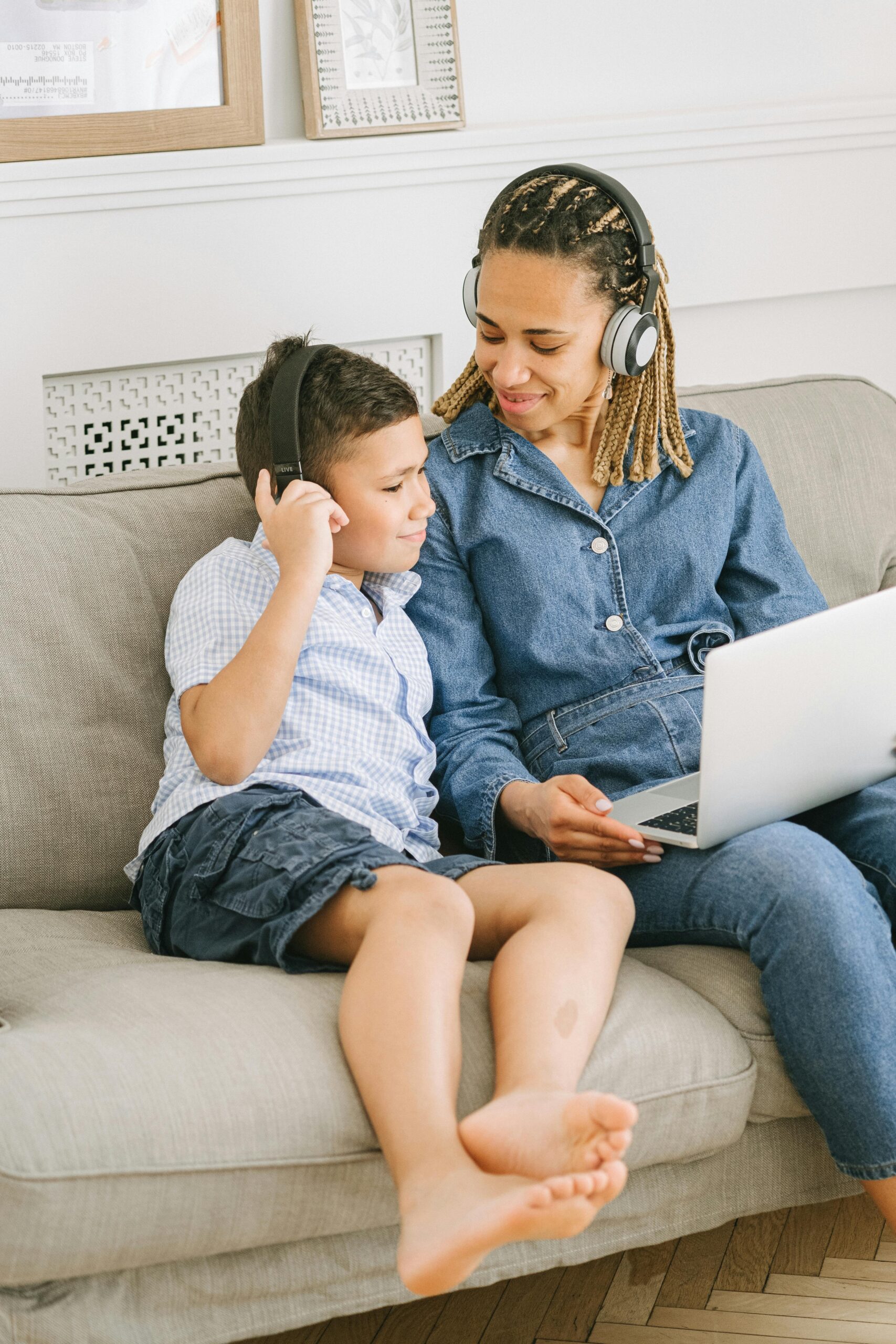 Mum and child on sofa looking at laptop