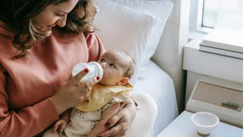 woman feeding baby