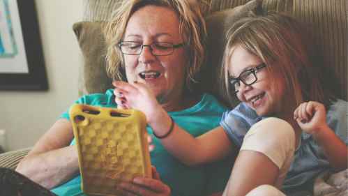 woman and child looking at tablet device together