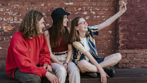 three teenagers posing for a selfie