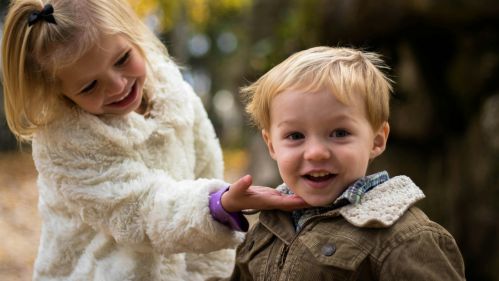 young siblings outside